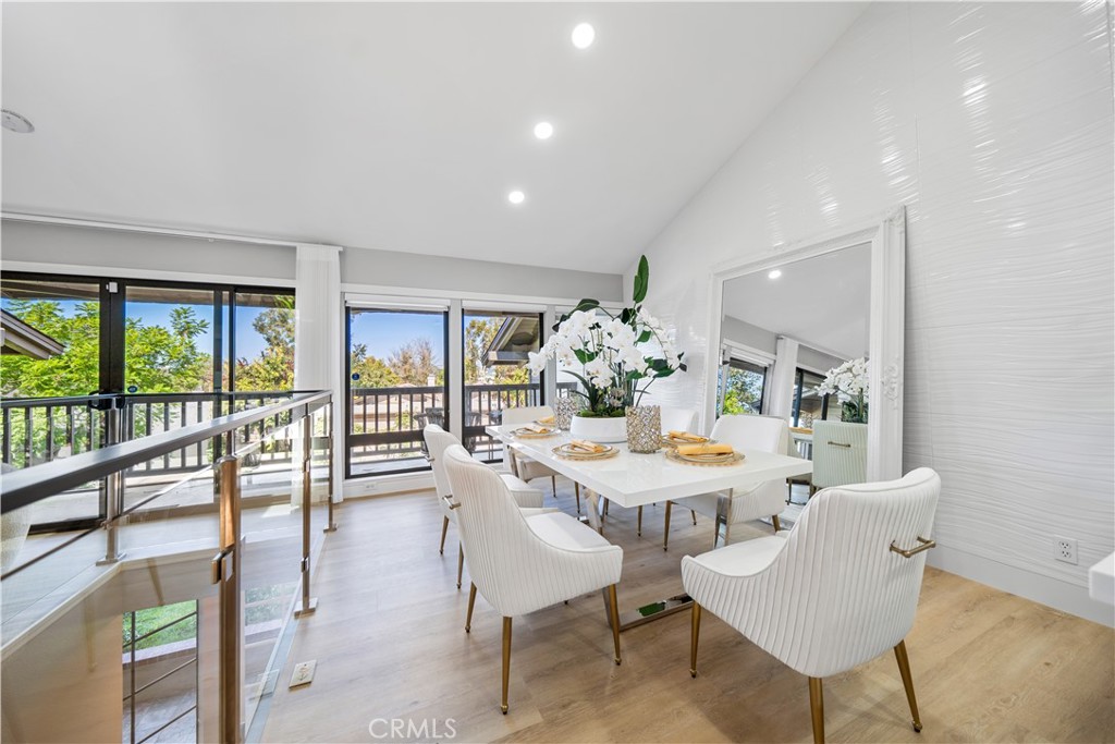 a view of a dining room with furniture large windows and wooden floor