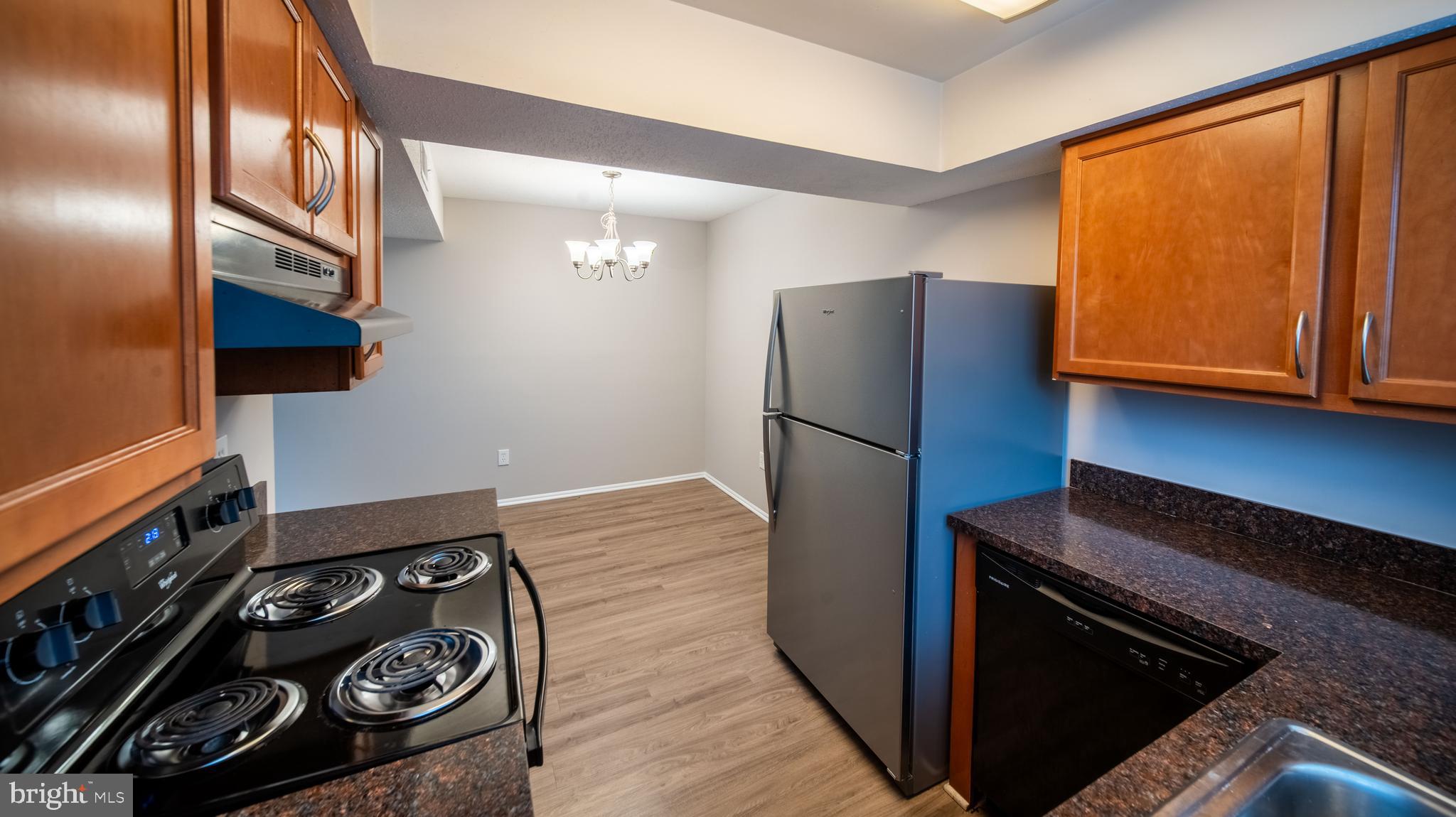 120 Fort Evans Road Southeast, Unit E Leesburg, VA 20175 - Photo 11 of 29 a kitchen with a stove and a refrigerator