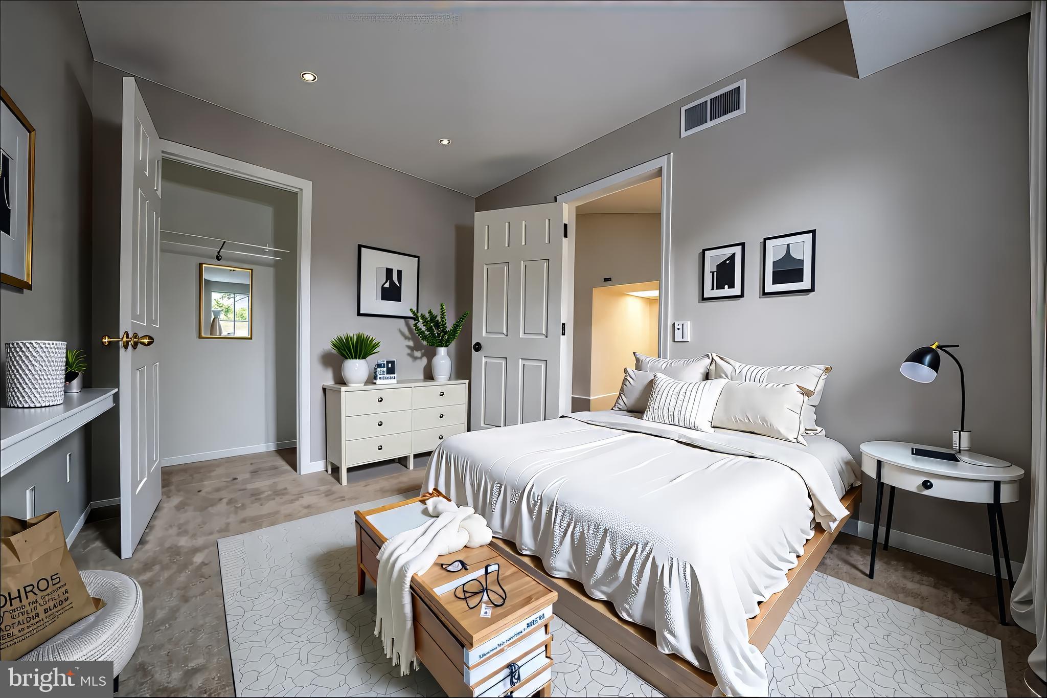 120 Fort Evans Road Southeast, Unit E Leesburg, VA 20175 - Photo 15 of 29 a spacious bedroom with a bed and a couch