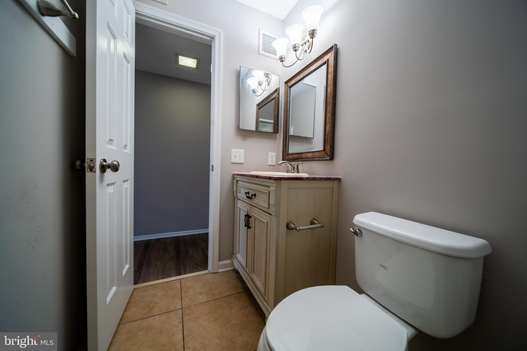 120 Fort Evans Road Southeast, Unit E Leesburg, VA 20175 - Photo 16 of 29 a white toilet sitting next to a bathroom sink