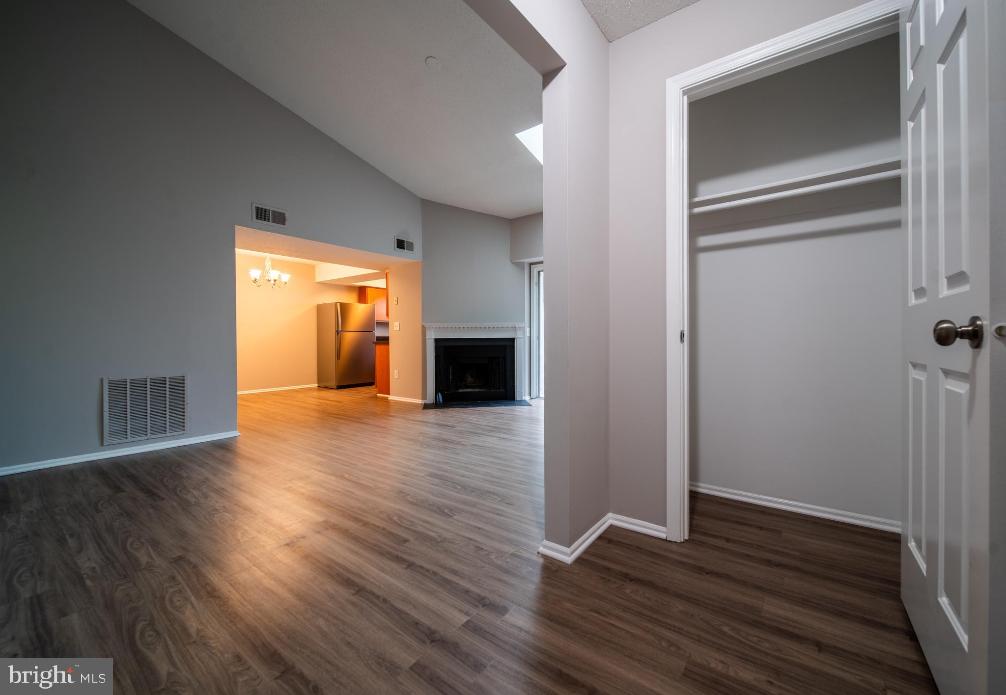 120 Fort Evans Road Southeast, Unit E Leesburg, VA 20175 - Photo 2 of 29 a view of empty room with wooden floor
