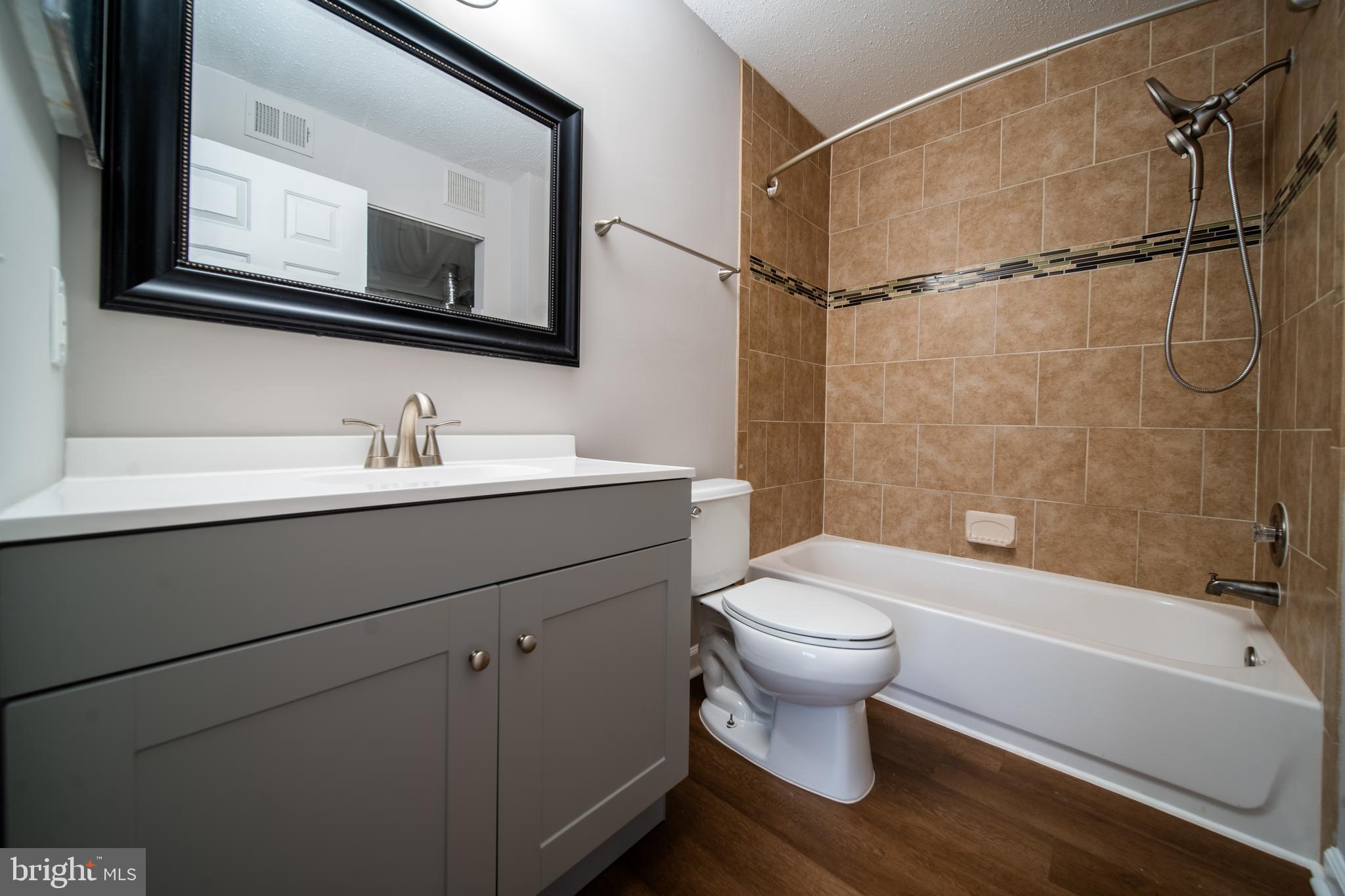 120 Fort Evans Road Southeast, Unit E Leesburg, VA 20175 - Photo 23 of 29 a bathroom with a sink a toilet and shower