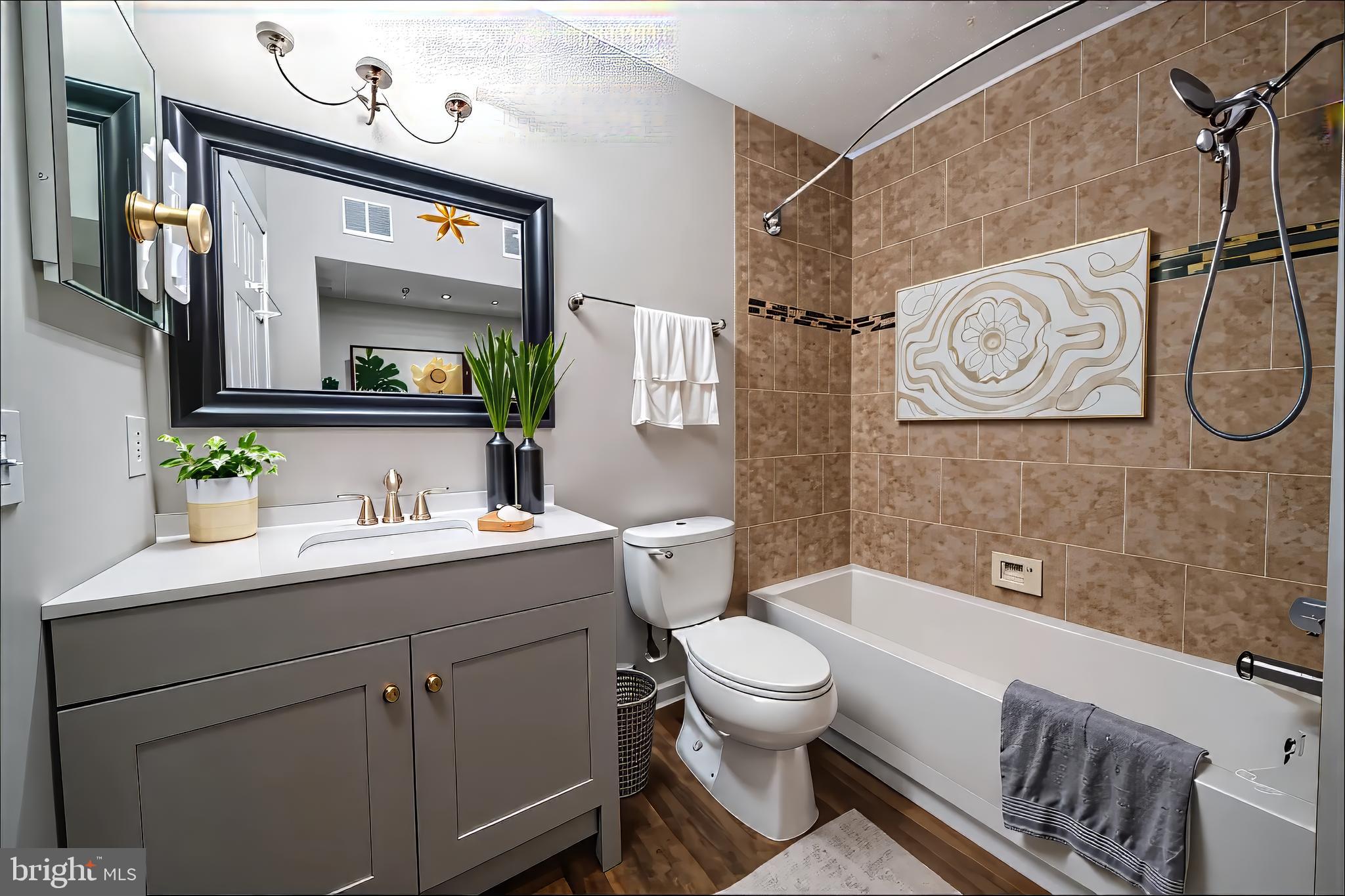 120 Fort Evans Road Southeast, Unit E Leesburg, VA 20175 - Photo 24 of 29 a bathroom with a toilet sink vanity tub and mirror