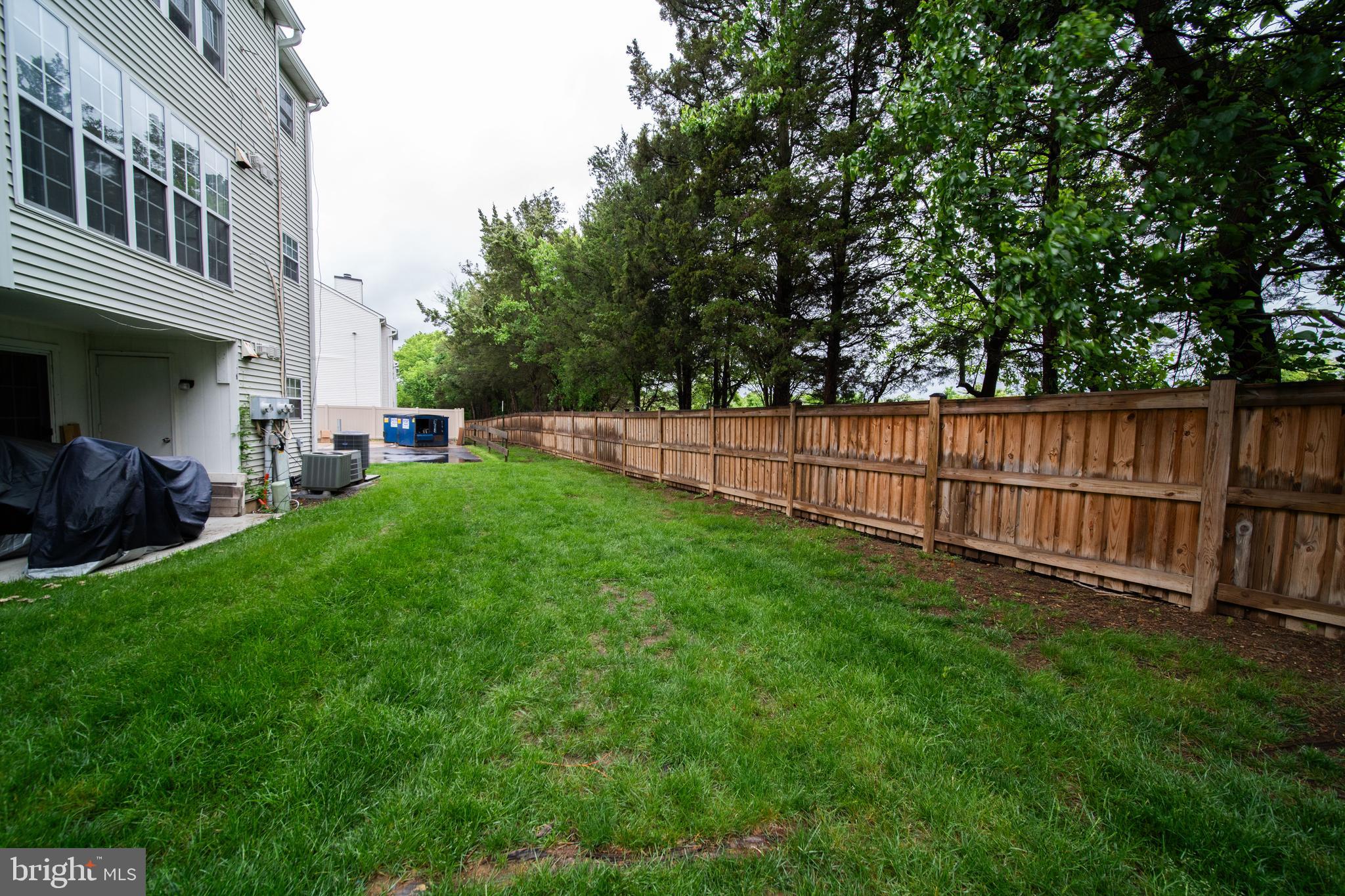 120 Fort Evans Road Southeast, Unit E Leesburg, VA 20175 - Photo 28 of 29 a view of a backyard with a garden and wooden fence