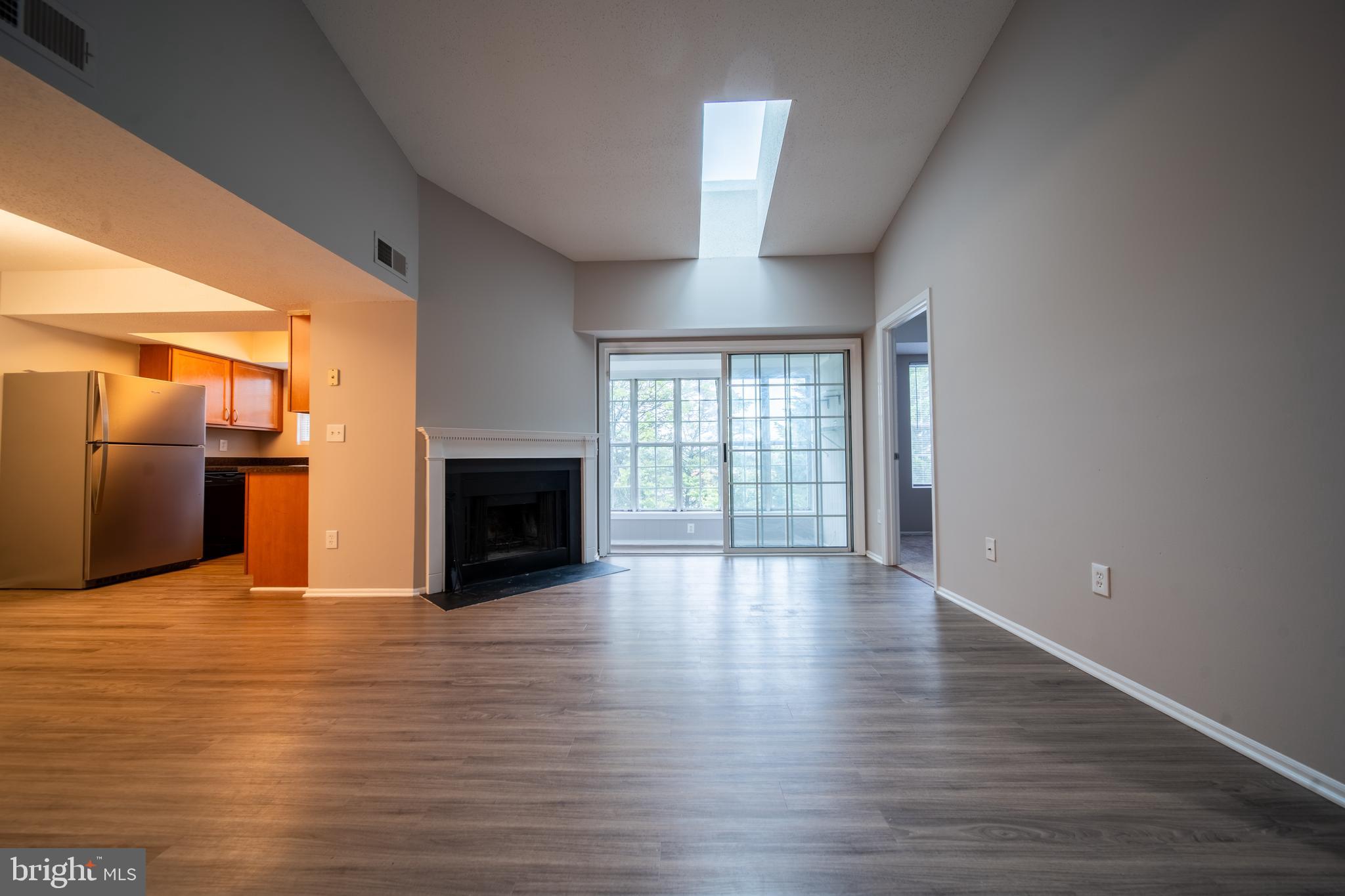 120 Fort Evans Road Southeast, Unit E Leesburg, VA 20175 - Photo 5 of 29 a view of a room with wooden floor and fireplace