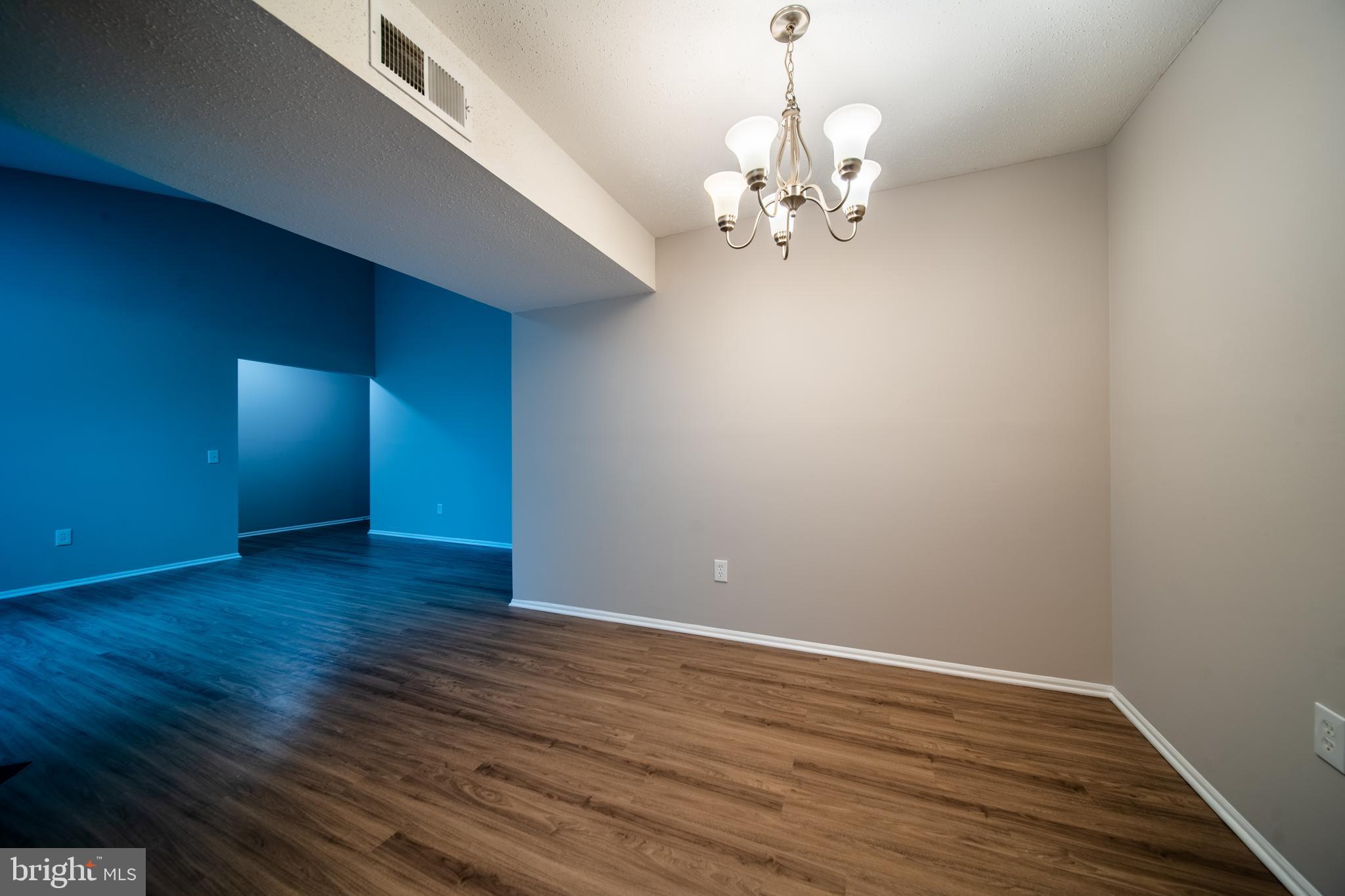 120 Fort Evans Road Southeast, Unit E Leesburg, VA 20175 - Photo 6 of 29 a view of an empty room with wooden floor