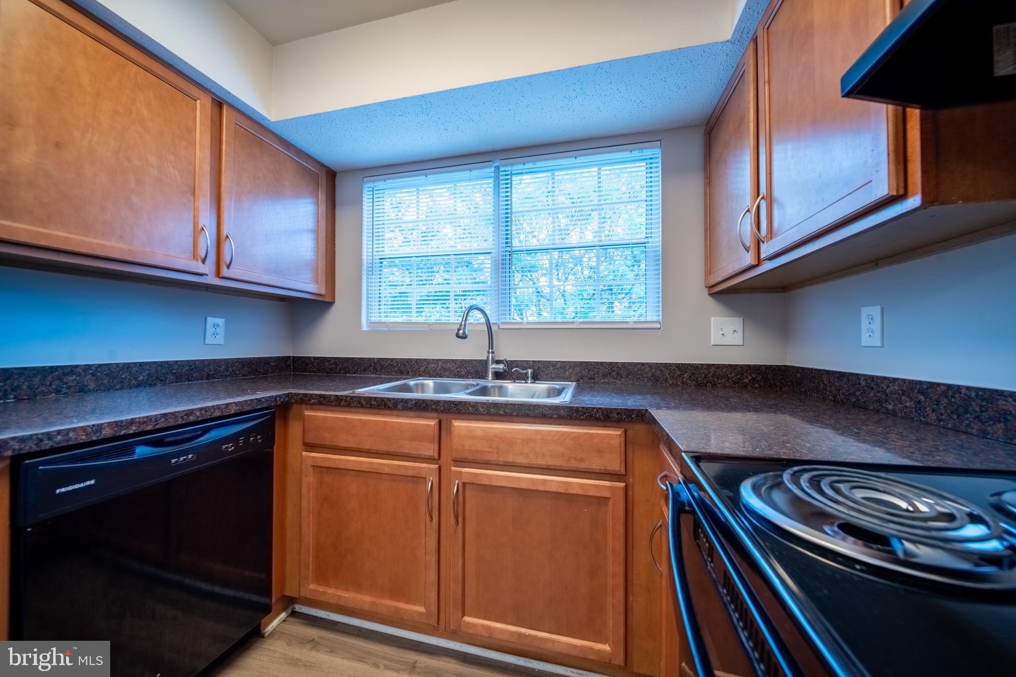 120 Fort Evans Road Southeast, Unit E Leesburg, VA 20175 - Photo 10 of 29 a kitchen with stainless steel appliances granite countertop a sink a stove and cabinets