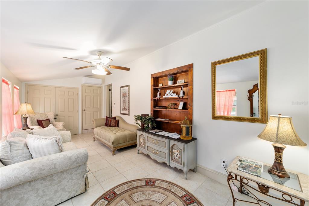 20693 Walnut Street Dunnellon, FL 34431 - Photo 3 of 51 a bedroom with furniture and a lamp