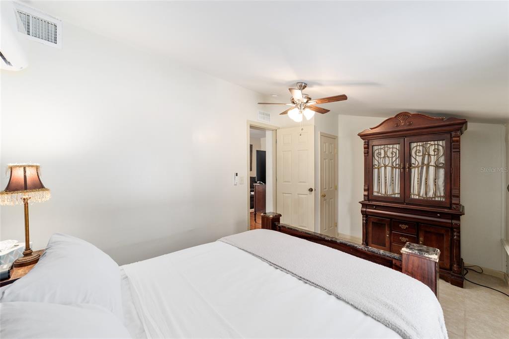 20693 Walnut Street Dunnellon, FL 34431 - Photo 34 of 51 a bedroom with a bed and a chandelier