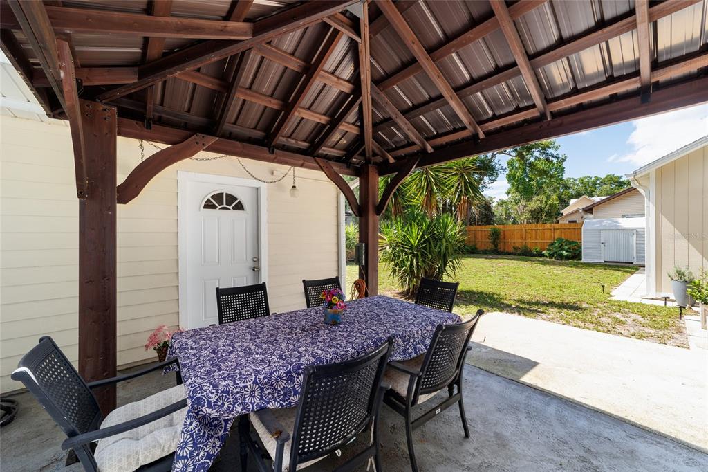 20693 Walnut Street Dunnellon, FL 34431 - Photo 36 of 51 a view of yard with table and chairs a barbeque