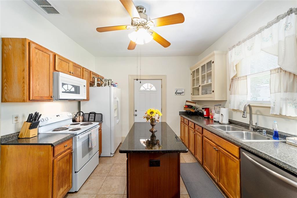 20693 Walnut Street Dunnellon, FL 34431 - Photo 6 of 51 a kitchen that has a lot of cabinets in it and wooden floors