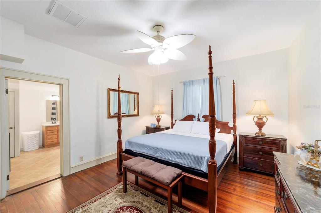 20693 Walnut Street Dunnellon, FL 34431 - Photo 7 of 51 a bed room with a bed a dresser and potted plant