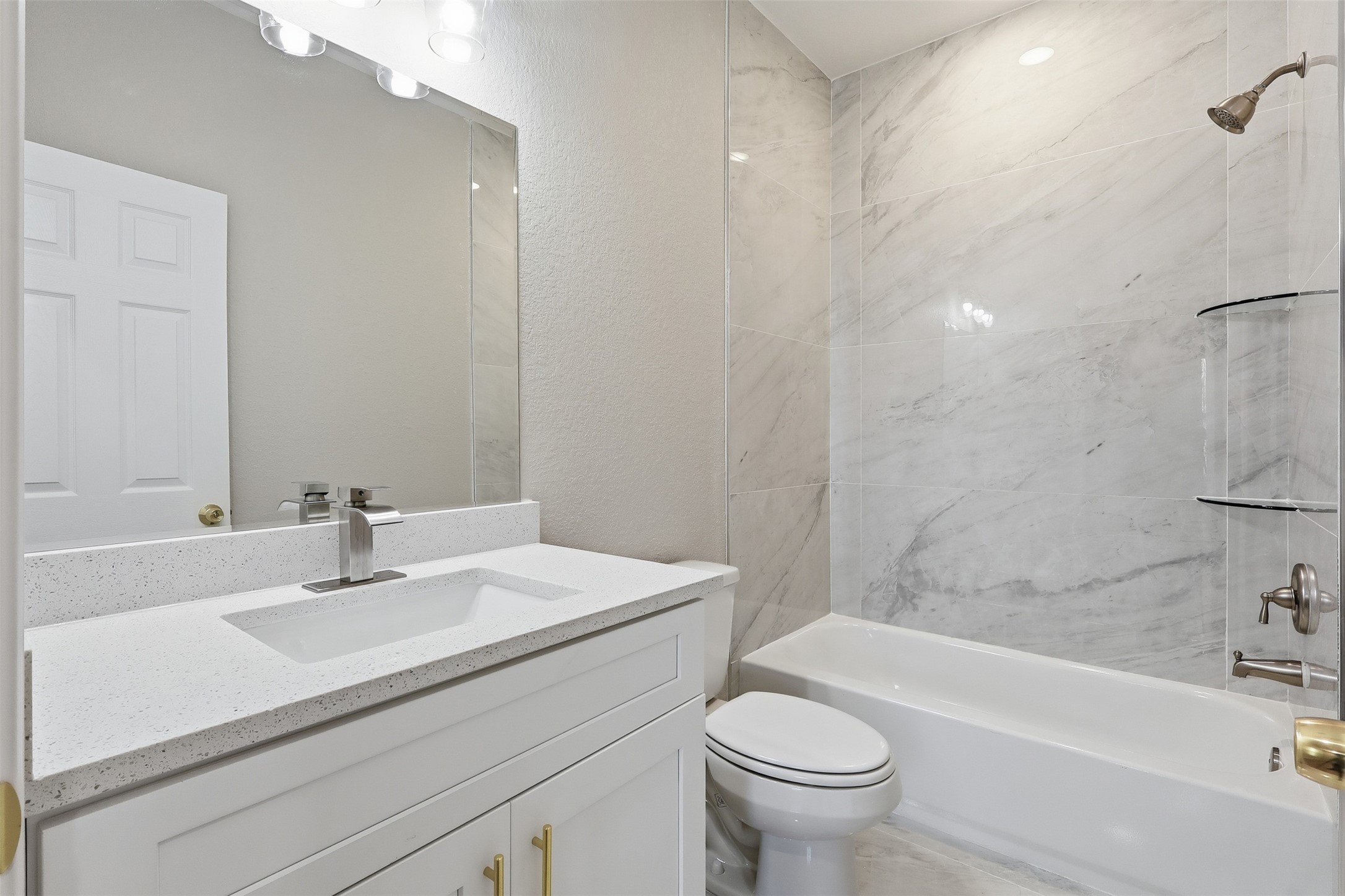 1915 Ross Avenue Cleveland, TX 77327 - Photo 11 of 11 a bathroom with a sink a toilet and a bathtub