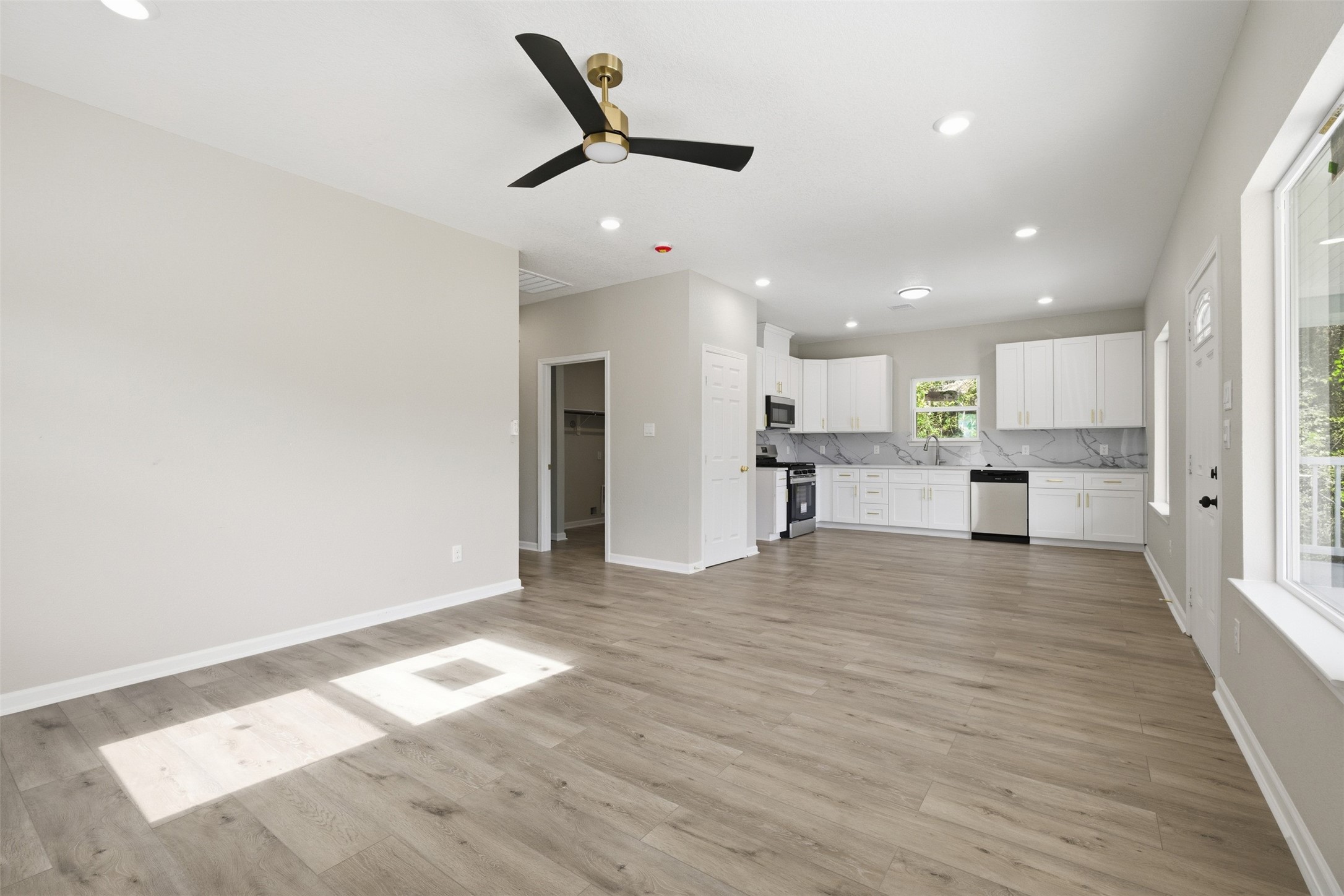 1915 Ross Avenue Cleveland, TX 77327 - Photo 4 of 11 a view of a kitchen with a refrigerator and a window
