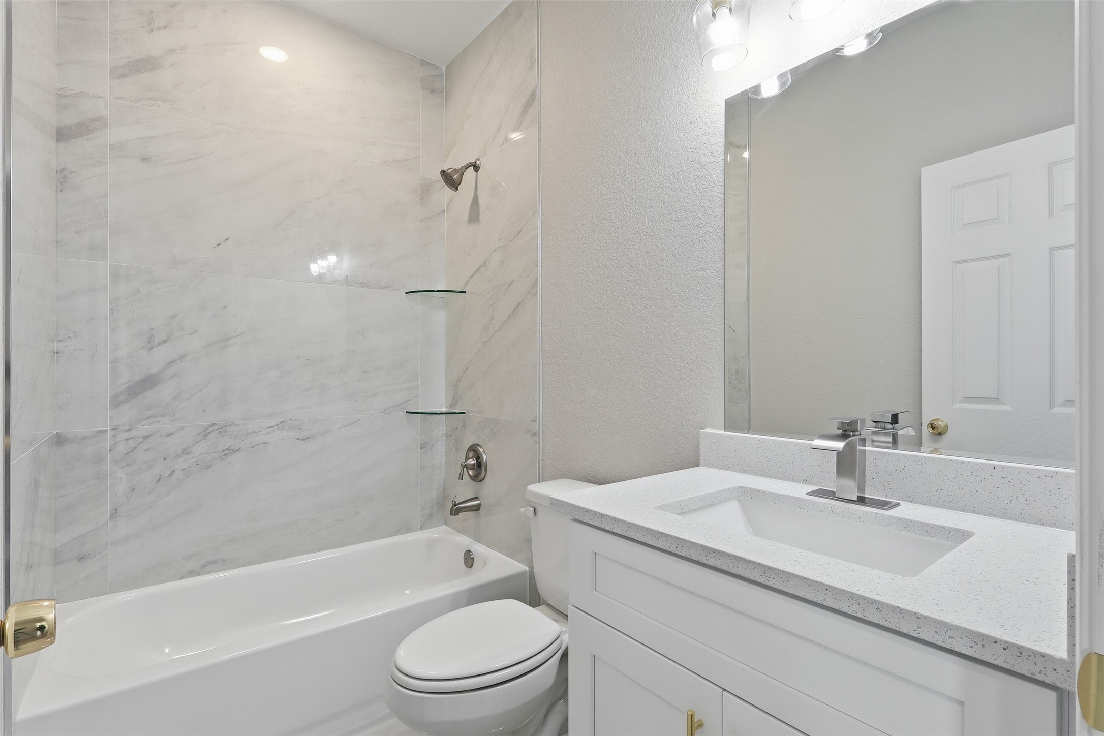 1915 Ross Avenue Cleveland, TX 77327 - Photo 6 of 11 a bathroom with a sink a toilet and a bathtub