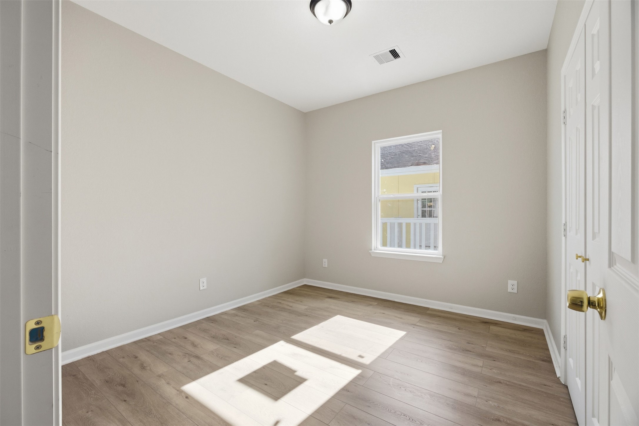 1915 Ross Avenue Cleveland, TX 77327 - Photo 7 of 11 a view of an empty room with wooden floor and a window