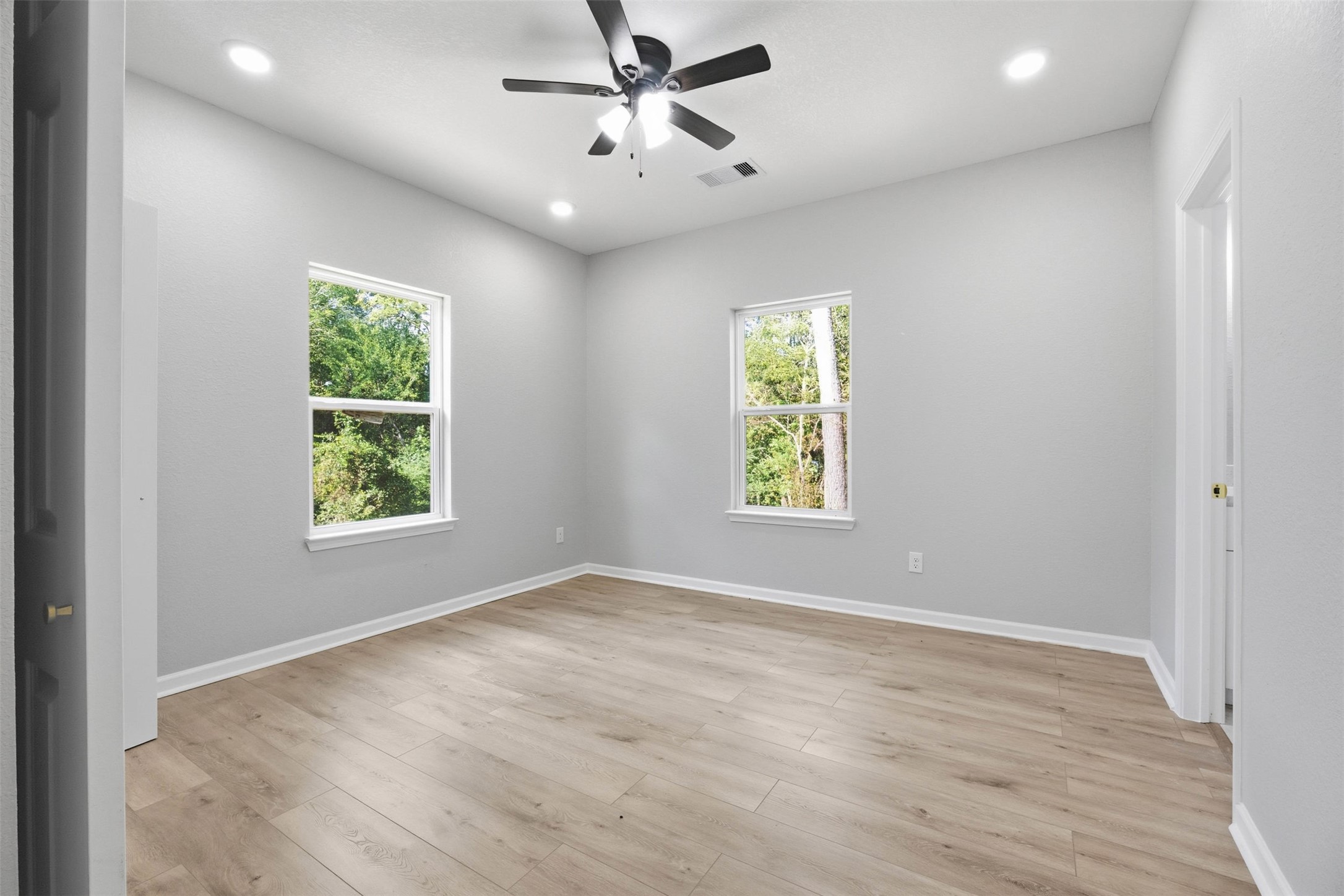 1915 Ross Avenue Cleveland, TX 77327 - Photo 9 of 11 wooden floor in an empty room with a window