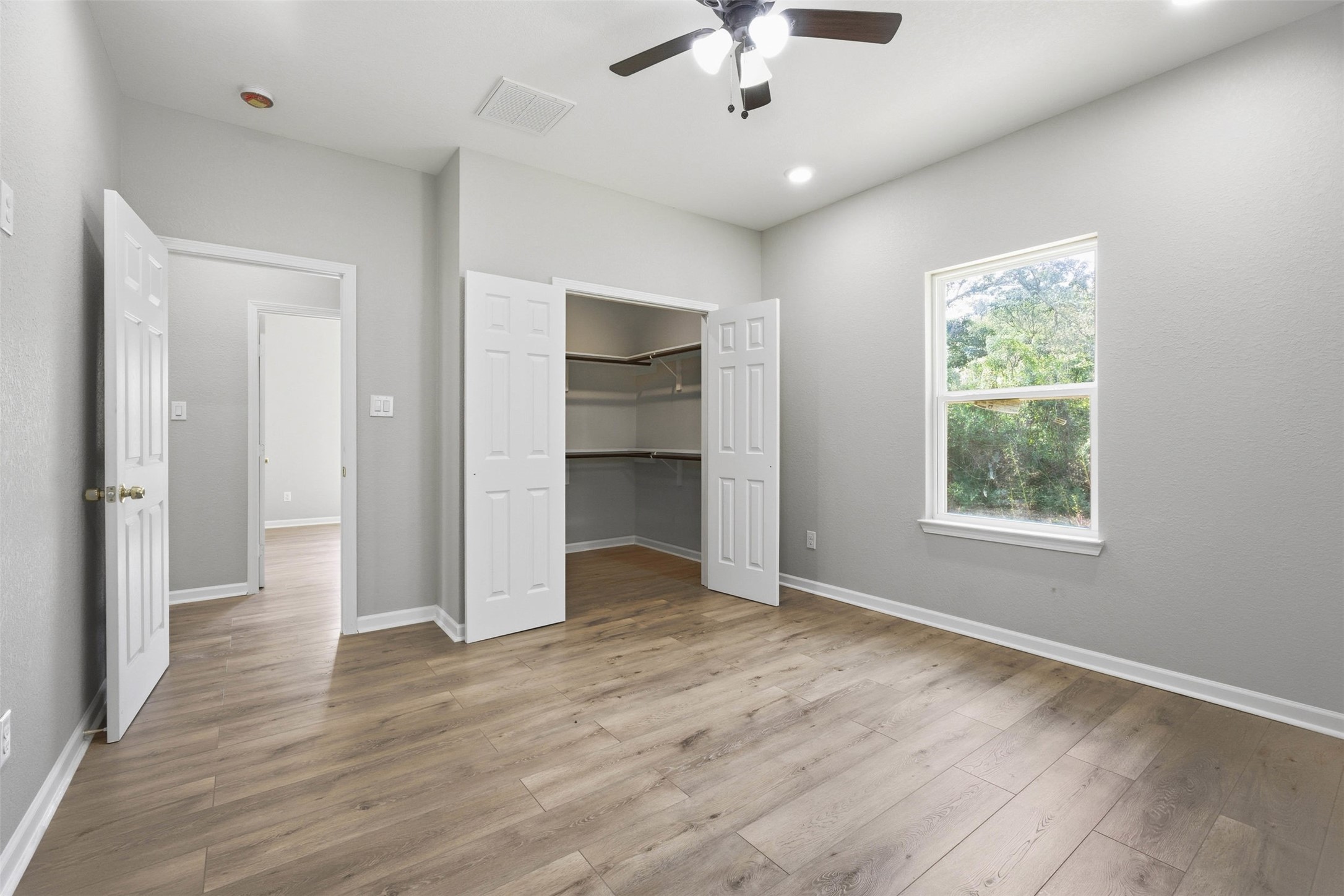 1915 Ross Avenue Cleveland, TX 77327 - Photo 10 of 11 an empty room with wooden floor chandelier and windows