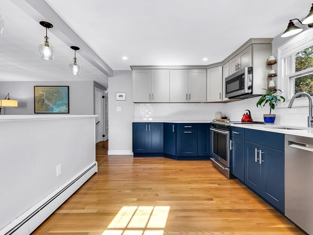 12 Adams Avenue Beverly, MA 01915 - Photo 12 of 31 a kitchen with stainless steel appliances granite countertop a stove a sink and a refrigerator