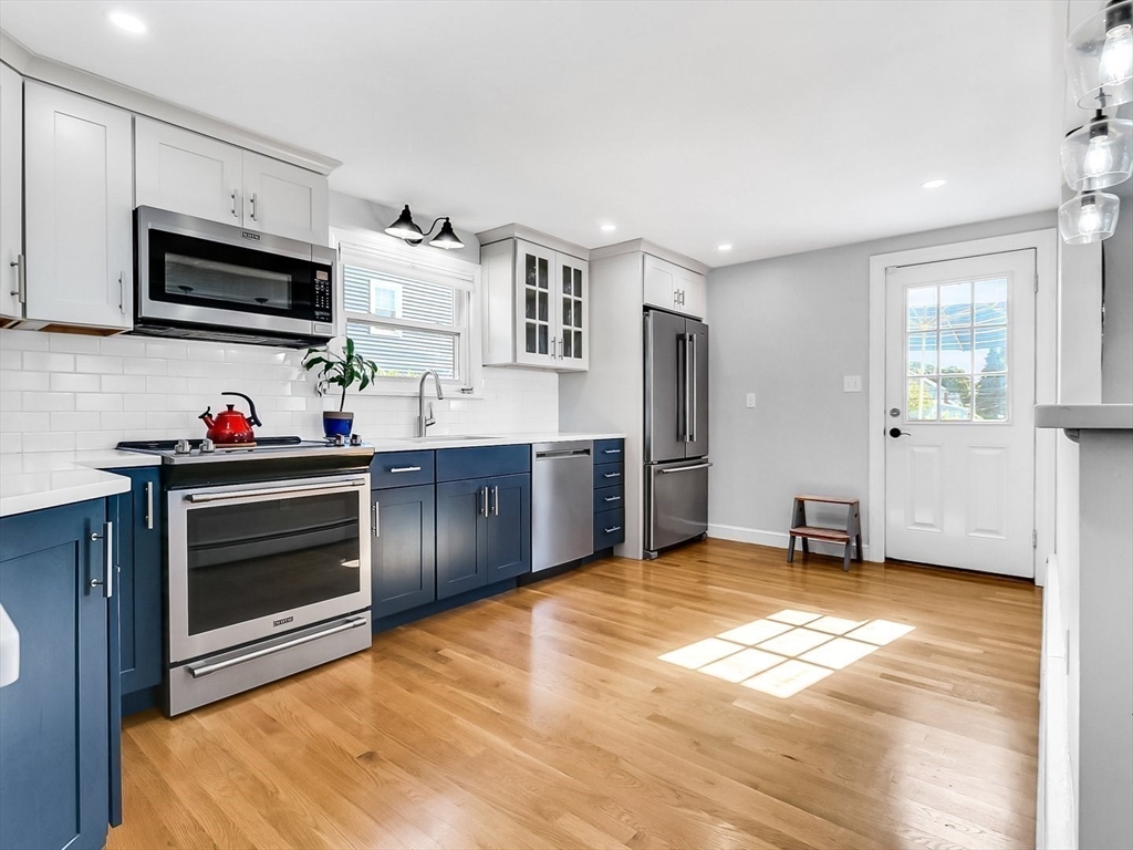 12 Adams Avenue Beverly, MA 01915 - Photo 13 of 31 a kitchen with stainless steel appliances a stove microwave and sink
