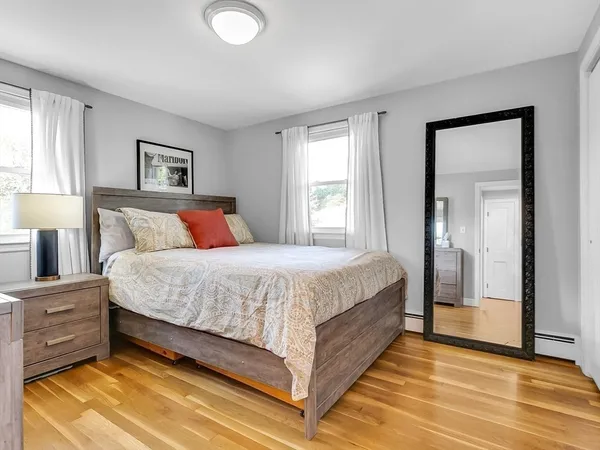 a bedroom with a bed and a night stand