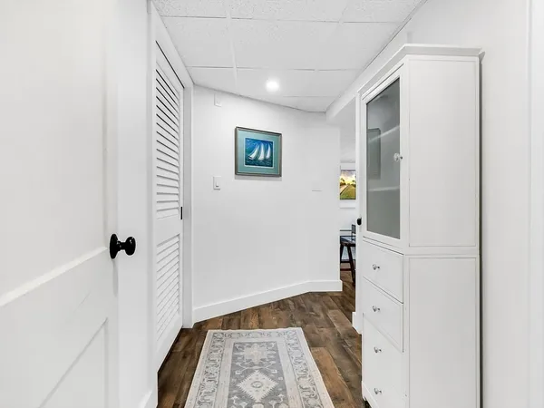 a view of a hallway with closet and front door
