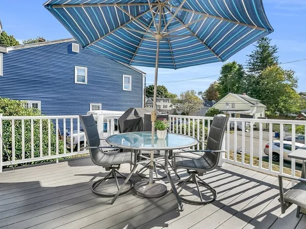 a view of a patio with table and chairs potted plants with wooden floor and fence