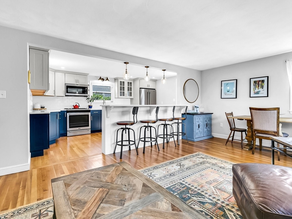 12 Adams Avenue Beverly, MA 01915 - Photo 7 of 31 a living room with stainless steel appliances furniture a rug and a view of kitchen