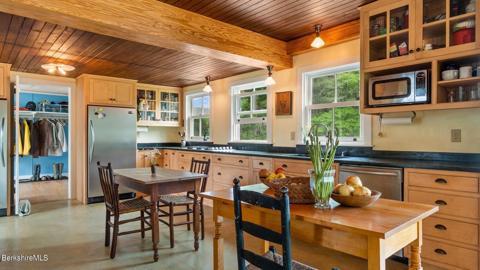 601 East River Road Chester, MA 01050 - Photo 12 of 49 a dining room with furniture and a floor to ceiling window