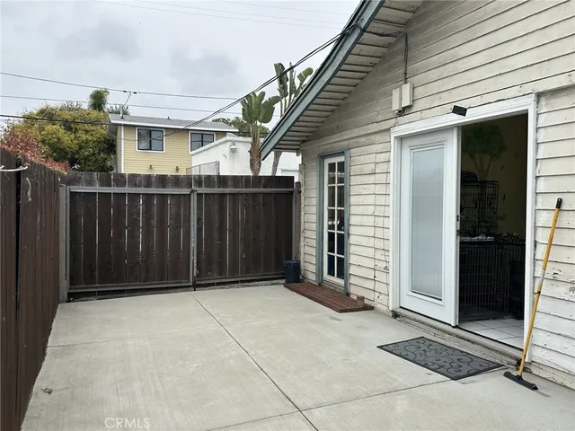 a view of a house with a wooden fence