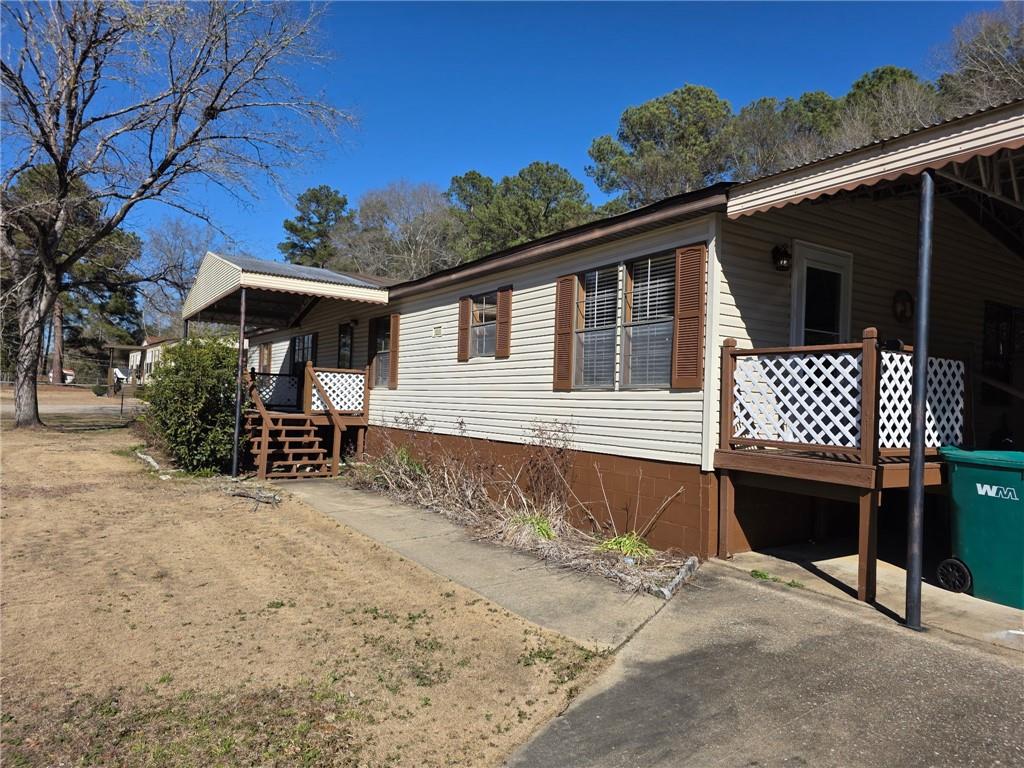129 Bishop Road Smiths Station, AL 36877 - Photo 23 of 24 View of home's exterior with a wooden deck