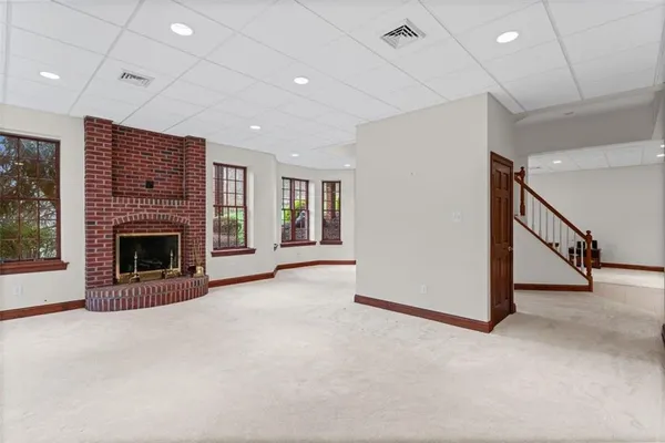 a view of a livingroom with an empty space and a fireplace
