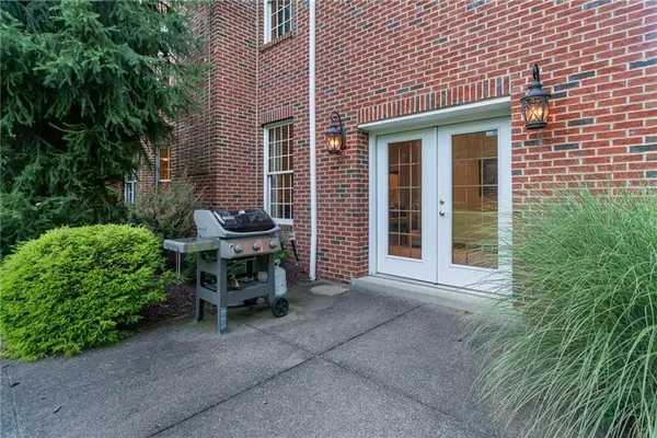 a view of a chair and table in backyard of the house
