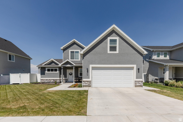 349 West 3085 South Logan, UT 84321 - Photo 37 of 37 Contemporary gray stucco exterior with white trim and a two-car garage