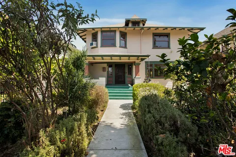 a front view of a house with a garden
