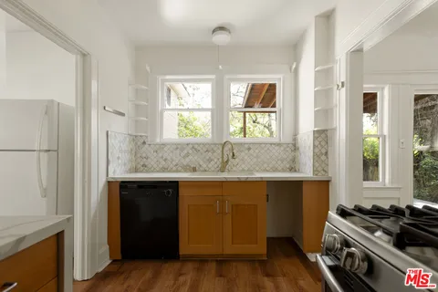 a kitchen with a sink stove and refrigerator
