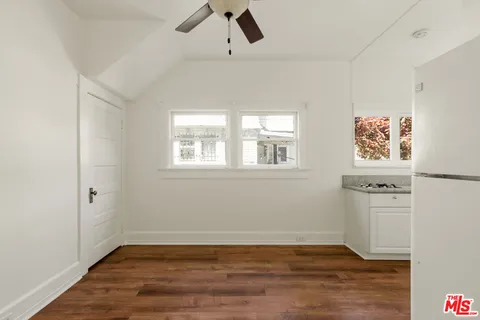 a view of a livingroom with wooden floor and a window