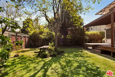 a view of backyard with swimming pool