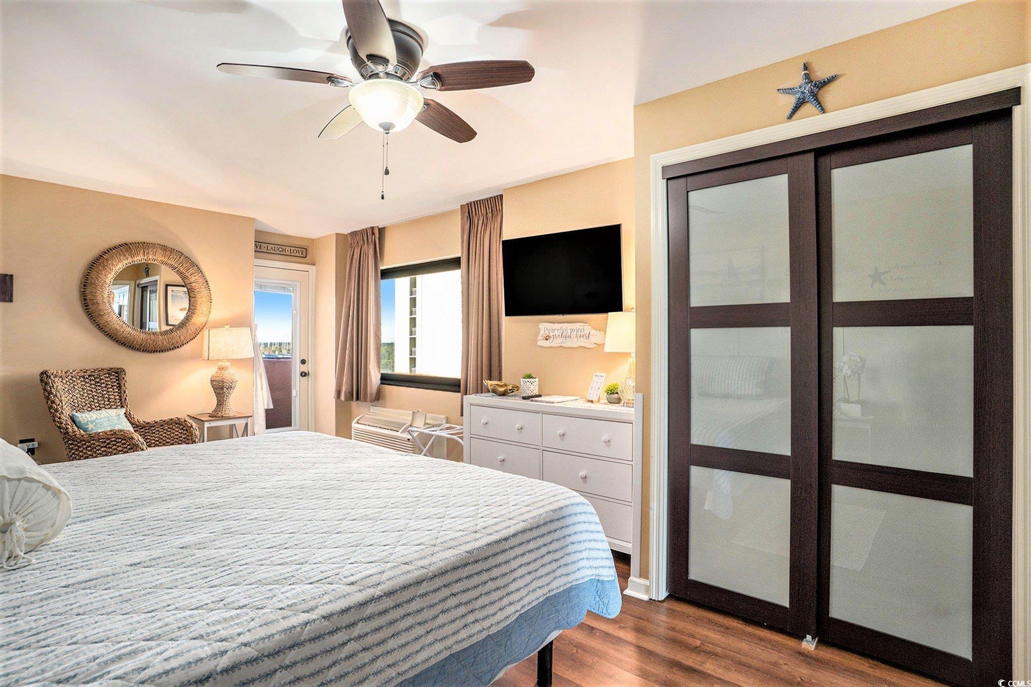 2406 North Ocean Boulevard, Unit 1203 Myrtle Beach, SC 29577 - Photo 10 of 24 Bedroom with dark wood-type flooring and a ceiling fan