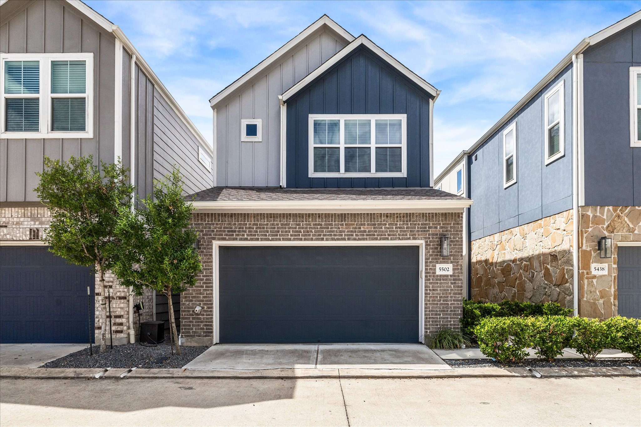 a front view of a house with garage