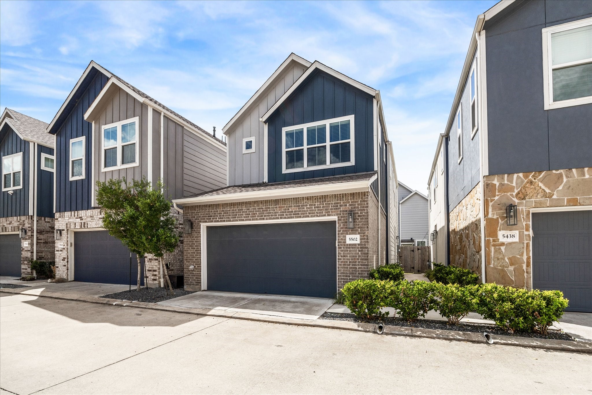 5502 Cuerta Street Houston, TX 77023 - Photo 2 of 25 a front view of a house with a yard and garage