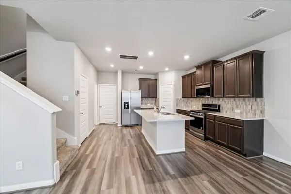 a view of a kitchen with sink stainless steel appliances and cabinets
