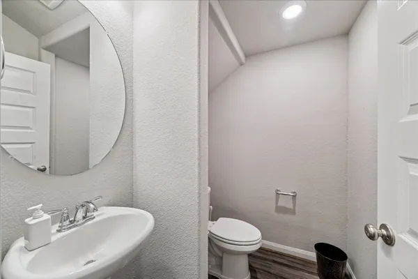 a bathroom with a sink toilet and a mirror