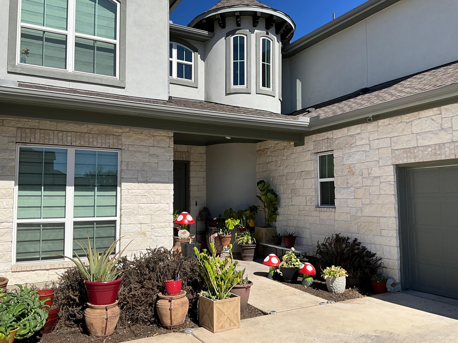 1837 Halflinger Lane Leander, TX 78641 - Photo 2 of 39 Property entrance with stone siding, stucco siding, a patio area, and roof with shingles