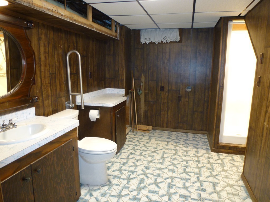 134 Dunstable Road North Chelmsford, MA 01863 - Photo 17 of 26 a bathroom with a sink a toilet a mirror and shower
