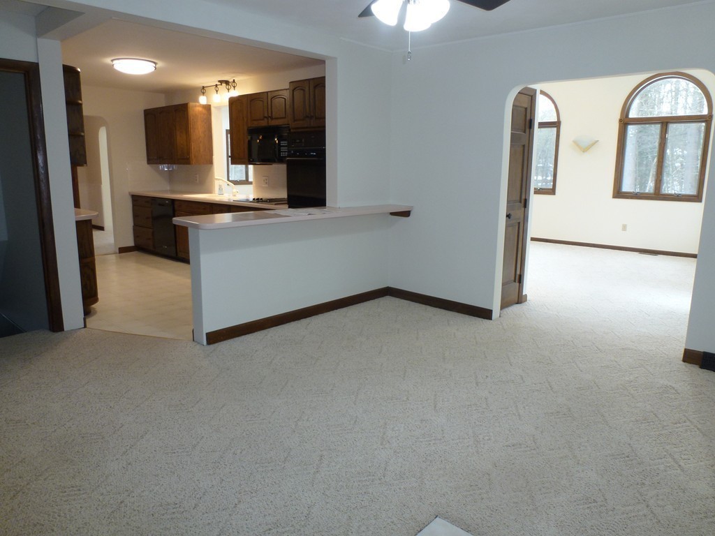 134 Dunstable Road North Chelmsford, MA 01863 - Photo 3 of 26 an empty room with a kitchen and a window