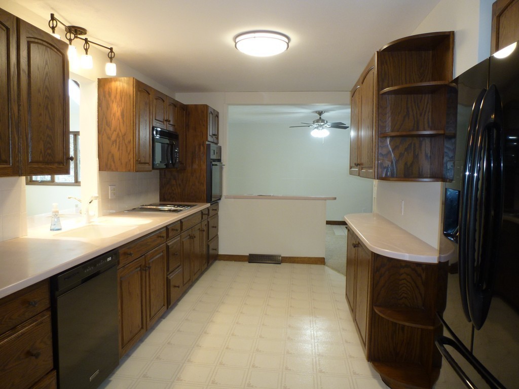 134 Dunstable Road North Chelmsford, MA 01863 - Photo 4 of 26 a bathroom with a sink a toilet a mirror and shower