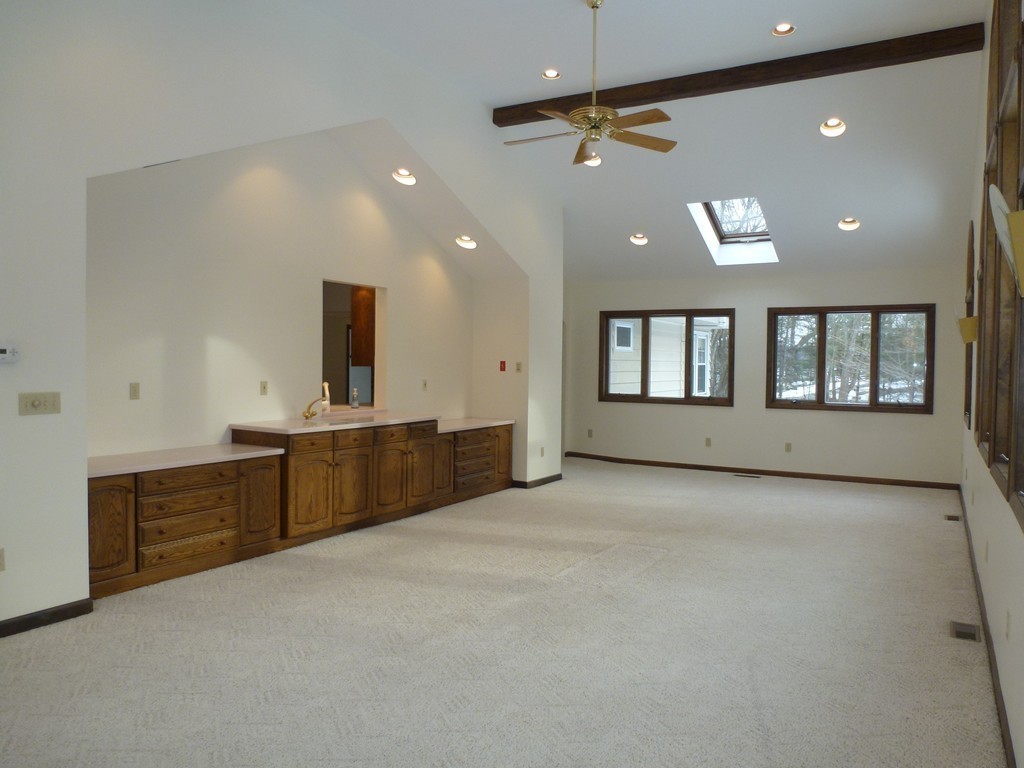 134 Dunstable Road North Chelmsford, MA 01863 - Photo 6 of 26 a view of an empty room with window and cabinet