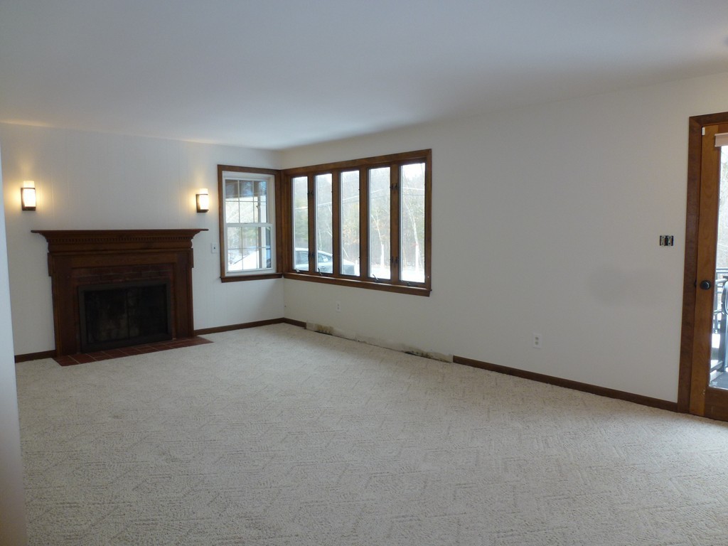 134 Dunstable Road North Chelmsford, MA 01863 - Photo 8 of 26 an empty room with a fireplace and window