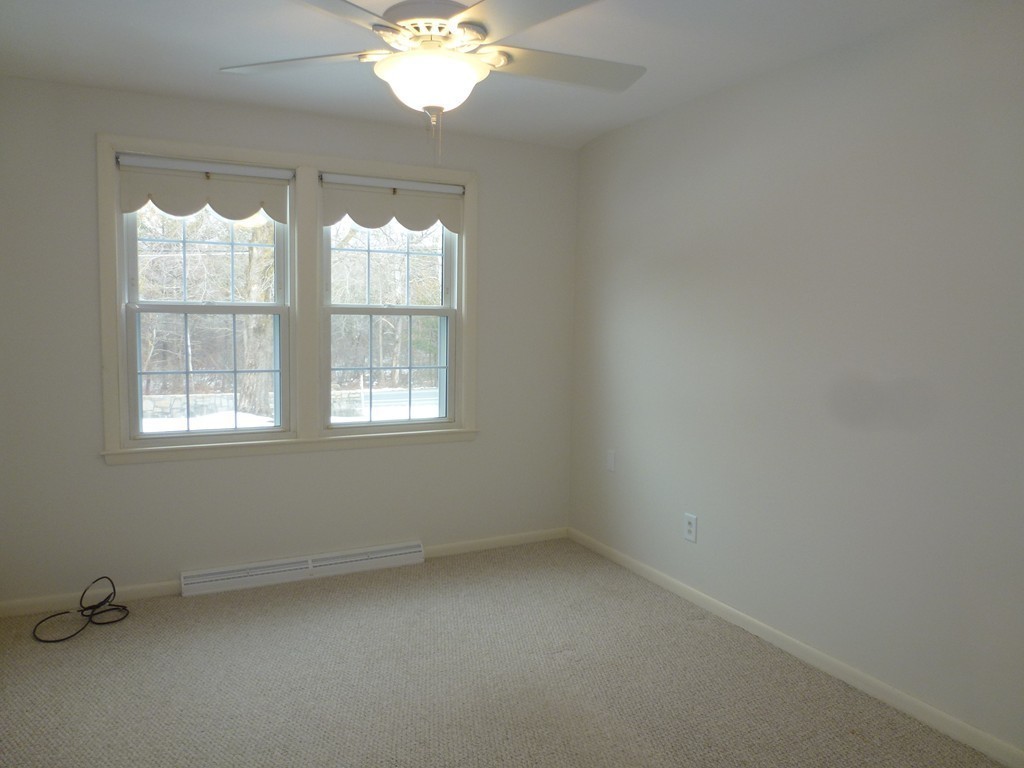 134 Dunstable Road North Chelmsford, MA 01863 - Photo 9 of 26 wooden floor in an empty room with a window